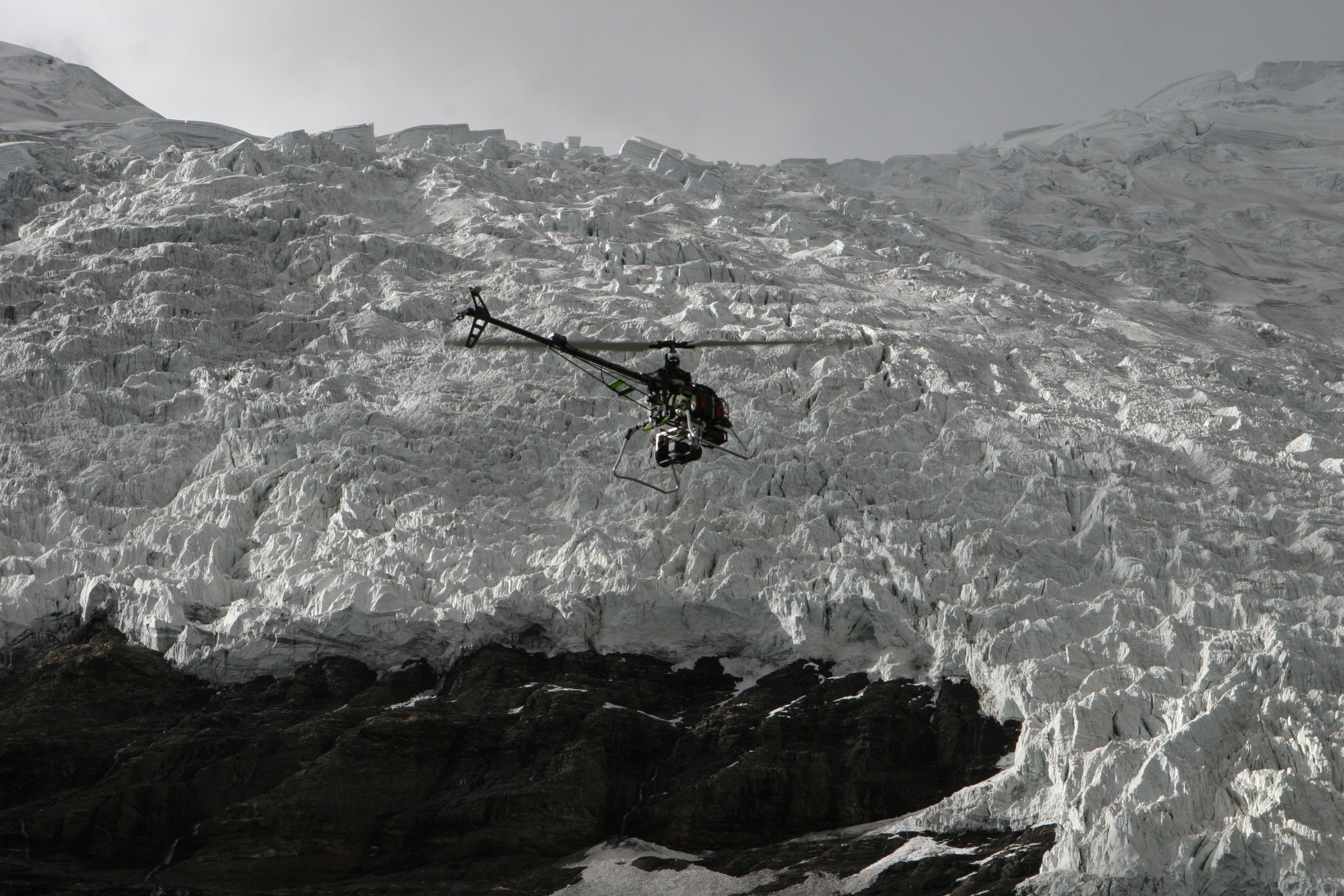 The helicopter flying over a glacier