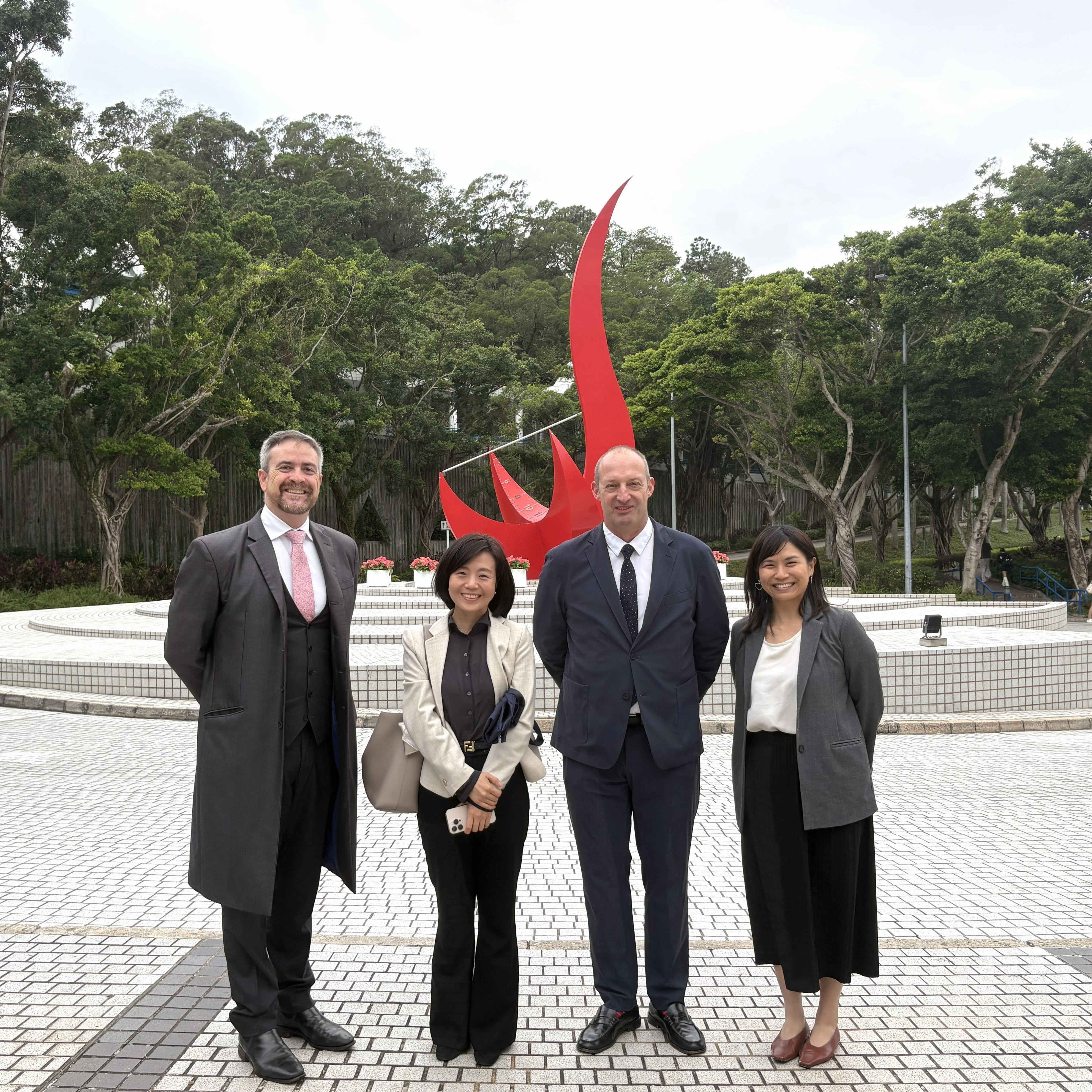A group photo of UNSW Sydney delegation and the representative of Global Engagement and Greater China Affairs Unit of HKUST in front of the “Red Bird” Sundial sculpture at the Piazza.